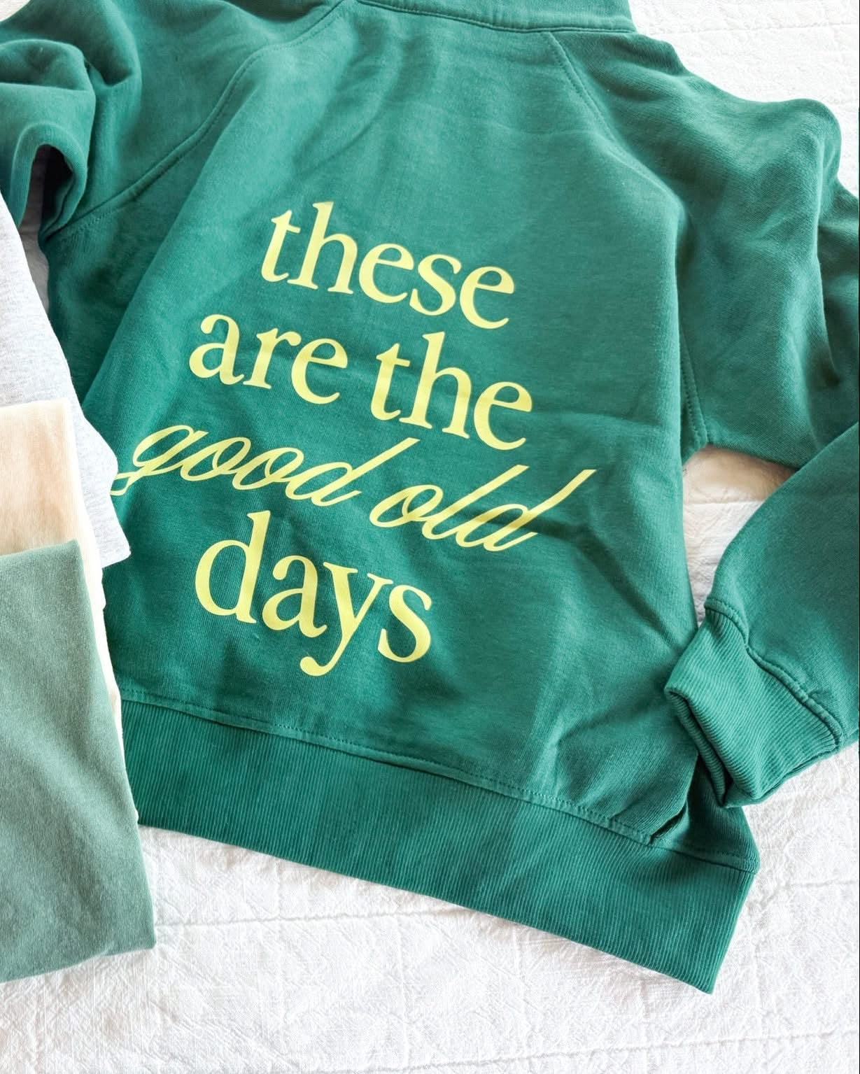 Green adult quarter zip with 'these are the good old days' printed on the back, seen on flat lay - Little Mama Shirt Shop