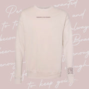Dust crewneck with "Permission To Be Optimistic" on chest and permission to be paragraph printed on sleeve, shown on flat lay - Little Mama Shirt Shop