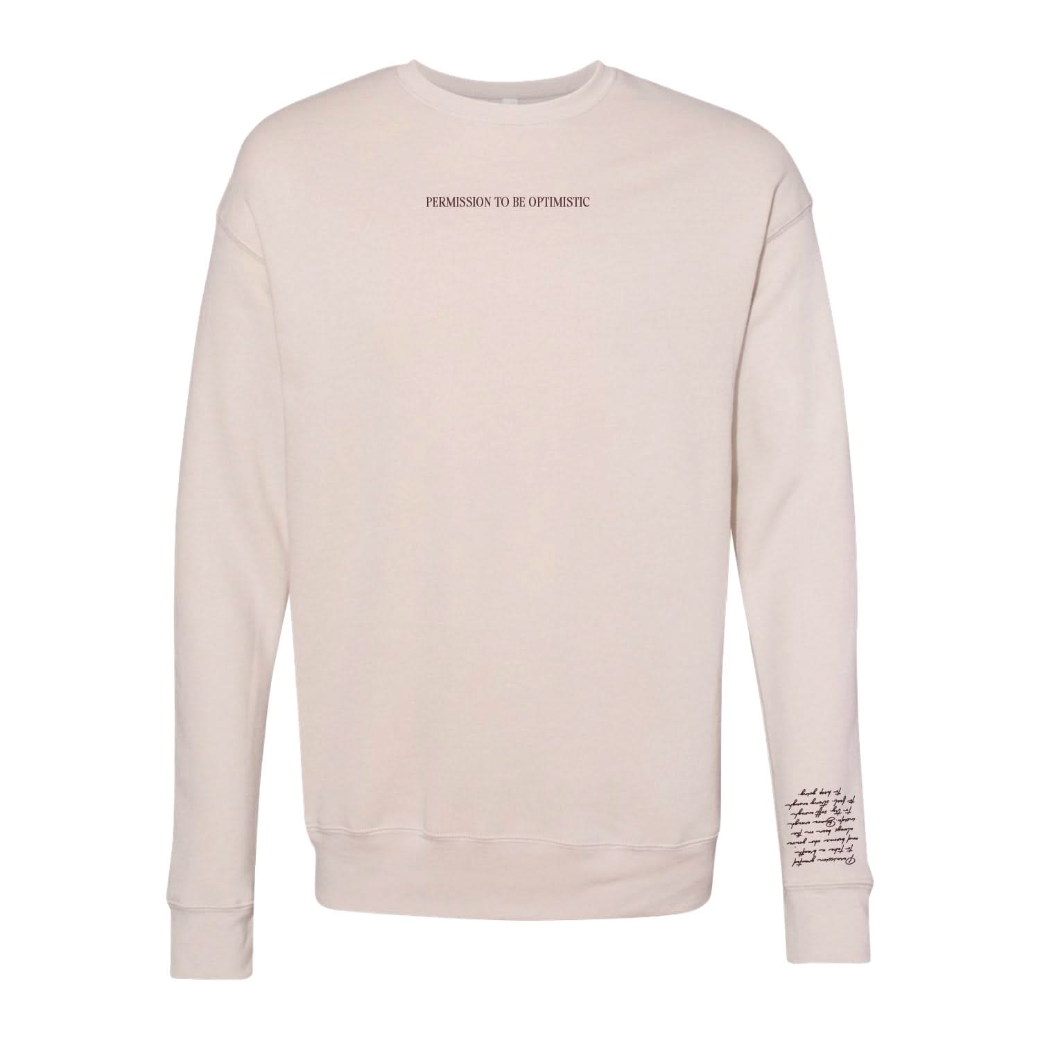Dust crewneck with "Permission To Be Optimistic" on chest and permission to be paragraph printed on sleeve, shown on flat lay - Little Mama Shirt Shop