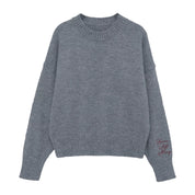 Gray sweater with "Brave, Soft, Strong" embroidered on the sleeve, seen on flat lay - Little Mama Shirt Shop