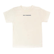Natural child tee with 'daily reminder' printed on front, seen on flat lay - Little Mama Shirt Shop