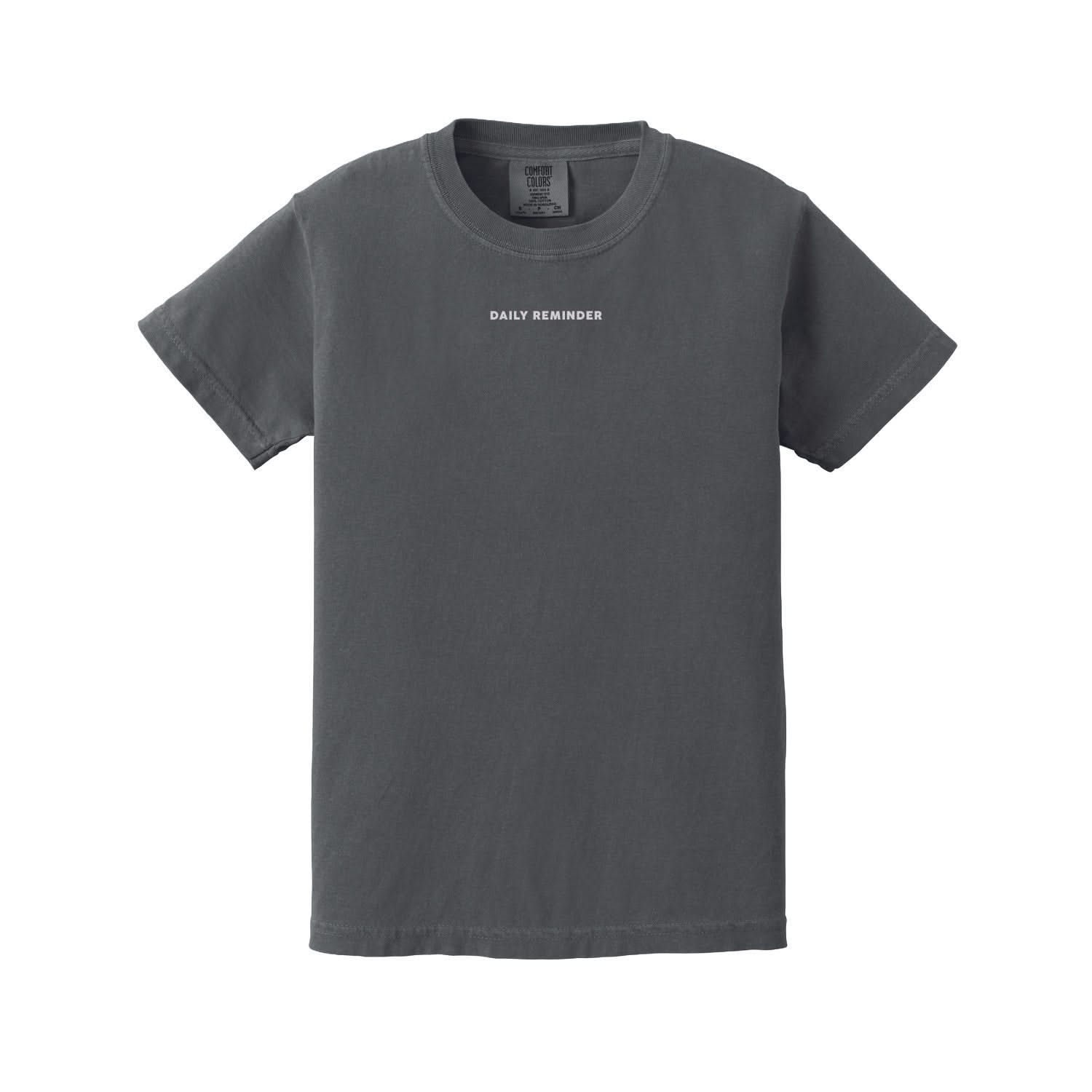 Pepper child comfort colors tee with 'daily reminder' printed on front, seen on flat lay - Little Mama Shirt Shop