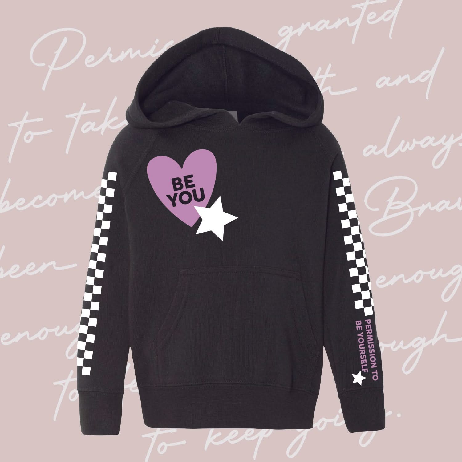 Child black sweater with checkers pattern on arm and Purple Heart with 'be you' in it flanked by a white star, seen on flat lay - Little Mama Shirt Shop