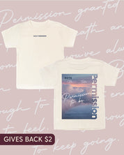 Natural child tee with permission to be cloud graphic on back and 'daily reminder' printed on front, seen on flat lay - Little Mama Shirt Shop