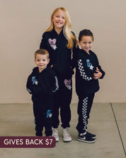 Child black sweater and joggers with checkers pattern on arm and leg, and Purple Heart or blue lightning bolt with 'be you' in it flanked by a white star, seen on models - Little Mama Shirt Shop
