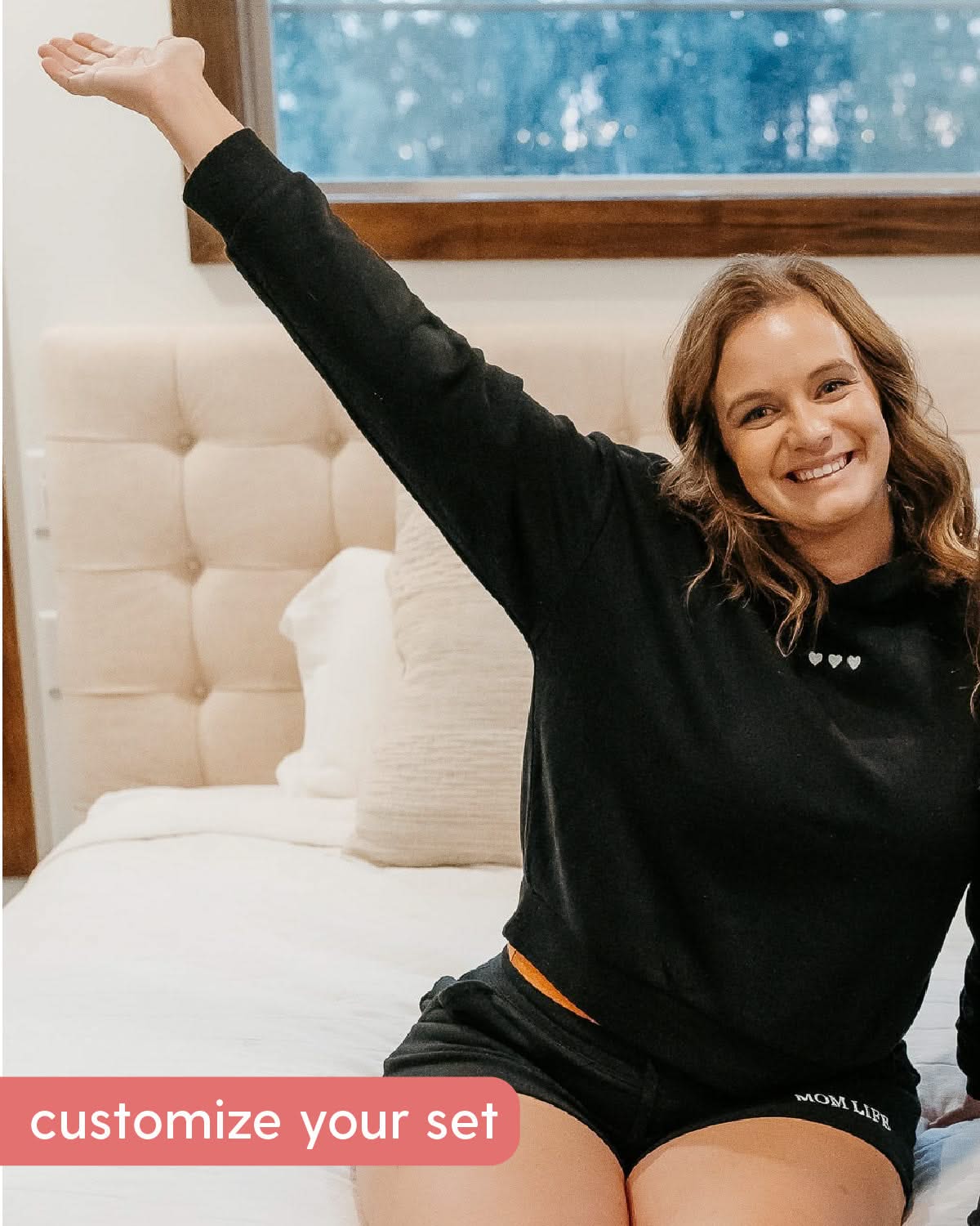 Hoodie front view black with white with three embroidered hearts on model - Little Mama Shirt Shop