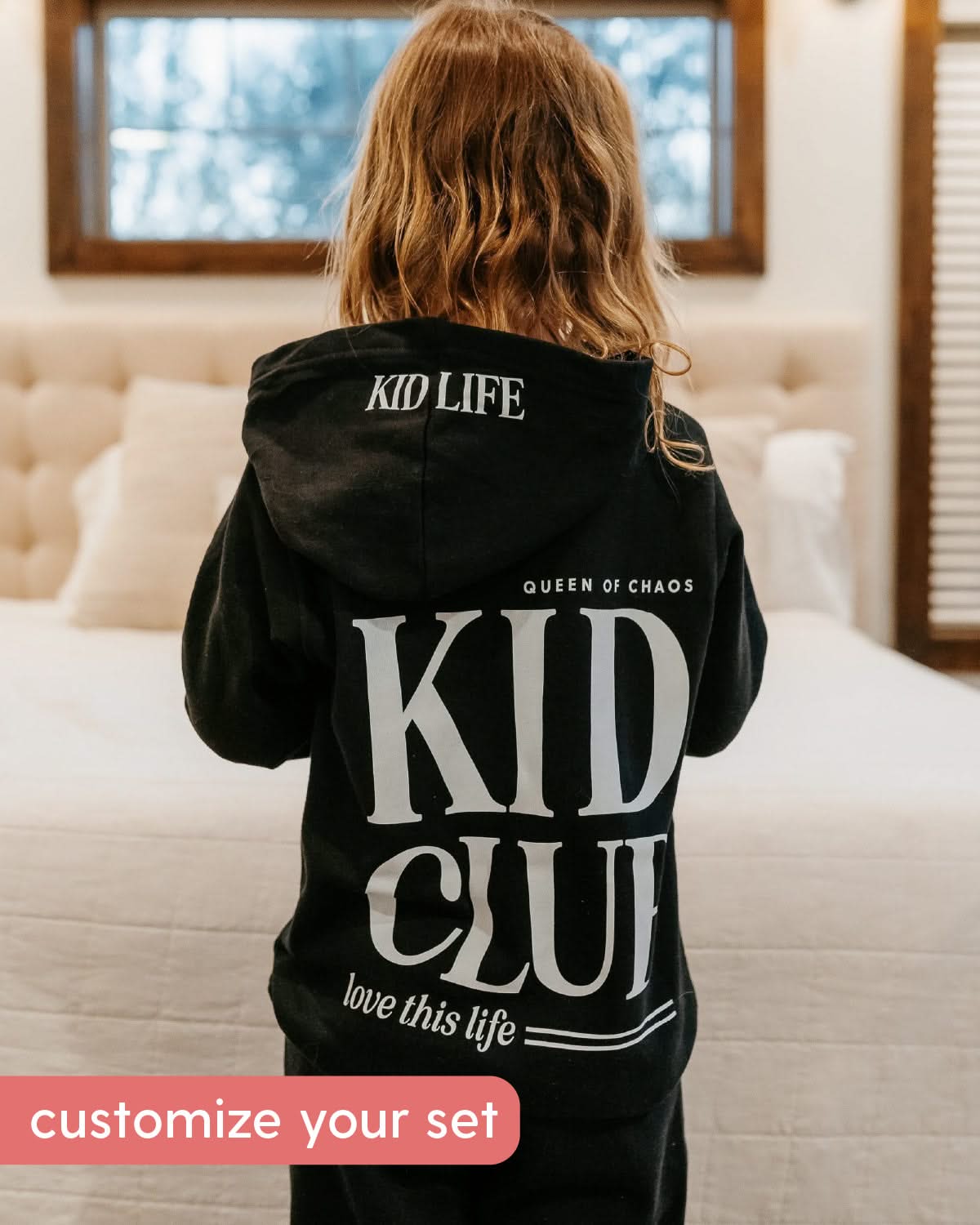 Hoodie back view in black with white 'Kid Club' graphic on model - Little Mama Shirt Shop