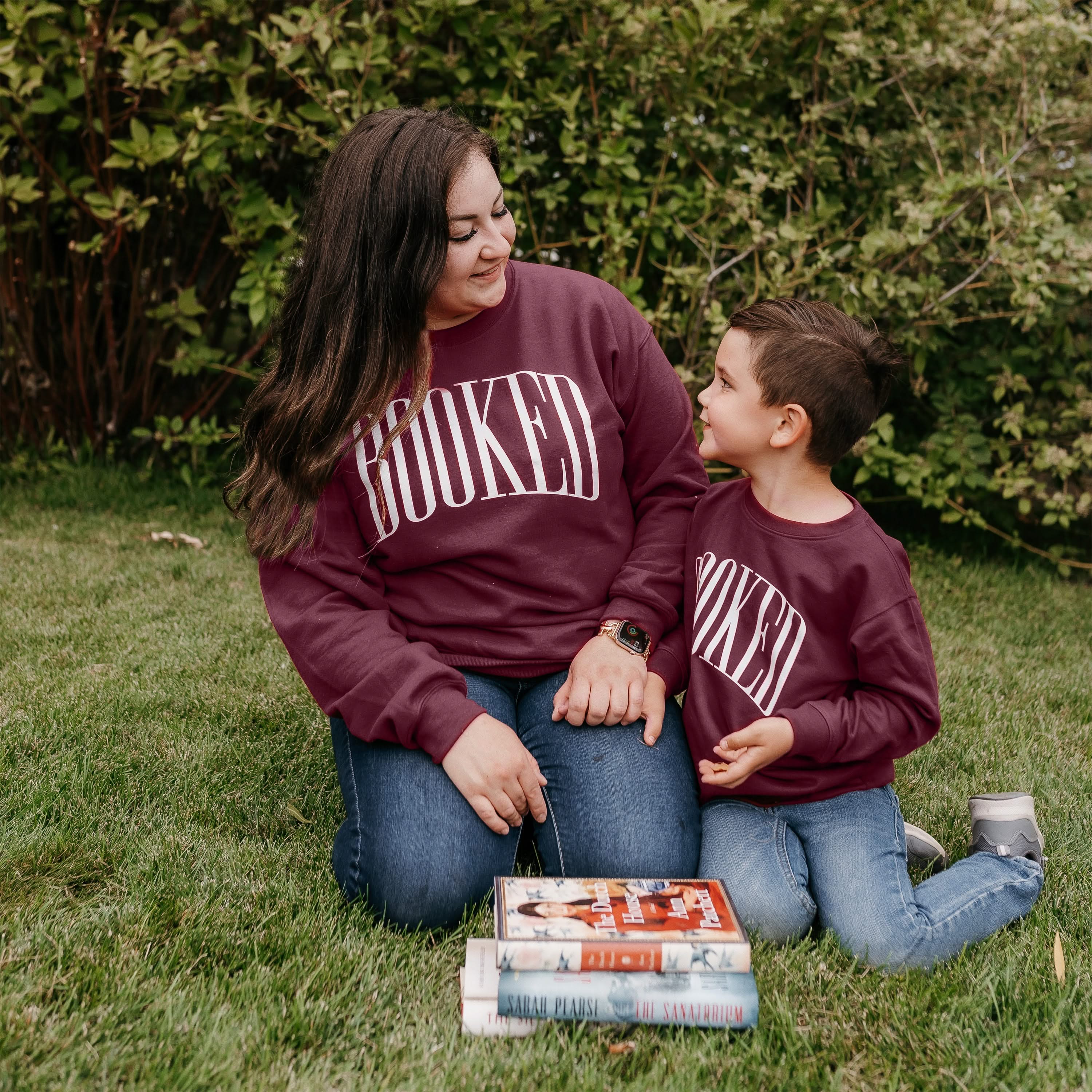 Mommy and me sweaters in maroon with 'BOOKED' graphic on chest, shown on models – Little Mama Shirt Shop