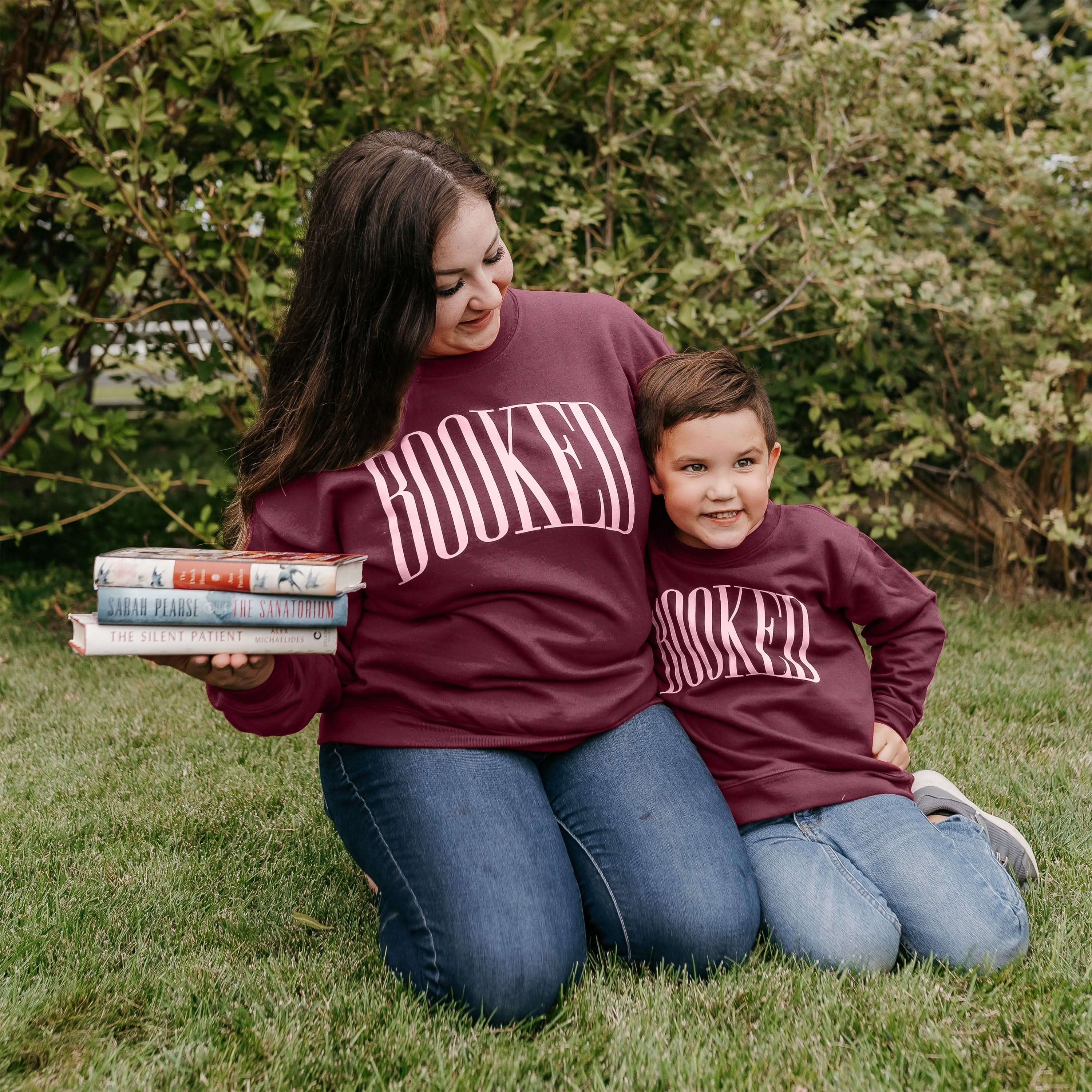 Mommy and me sweaters in maroon with 'BOOKED' graphic on chest, shown on models – Little Mama Shirt Shop