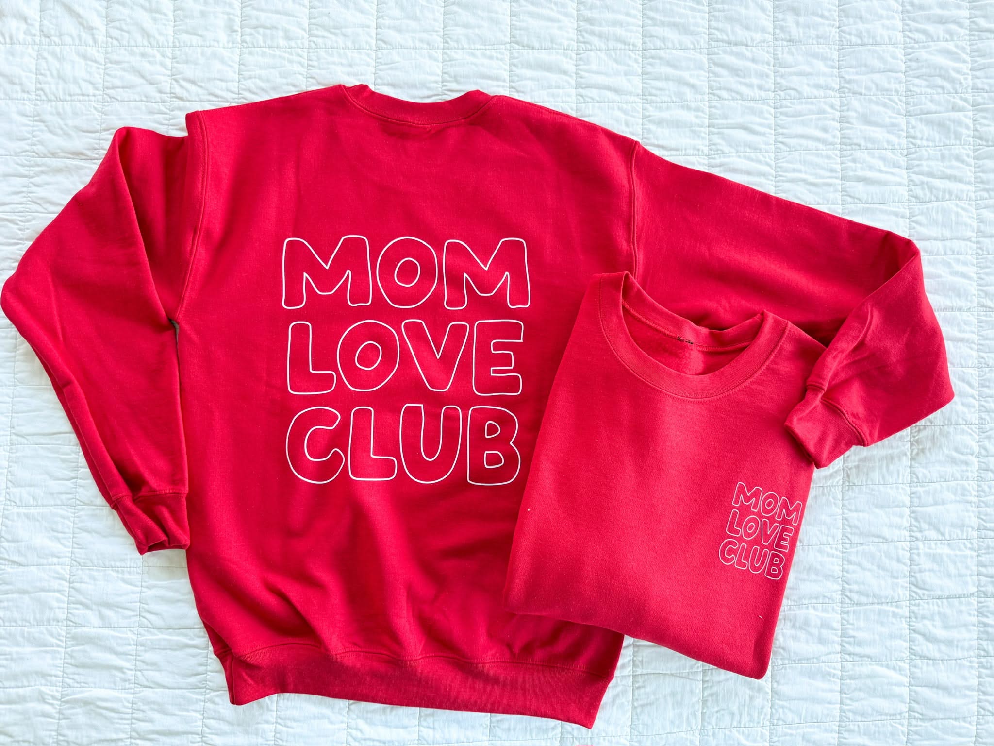 Adult sweater in red with "Mom Love Club" bubble letter text design on back and front left chest small, shown on flat lay – Little Mama Shirt Shop