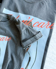 Child tee with "I Don't Care" retro cassette on front and "JK I Actually Do" text on sleeve, shown on flat lay  – Little Mama Shirt Shop