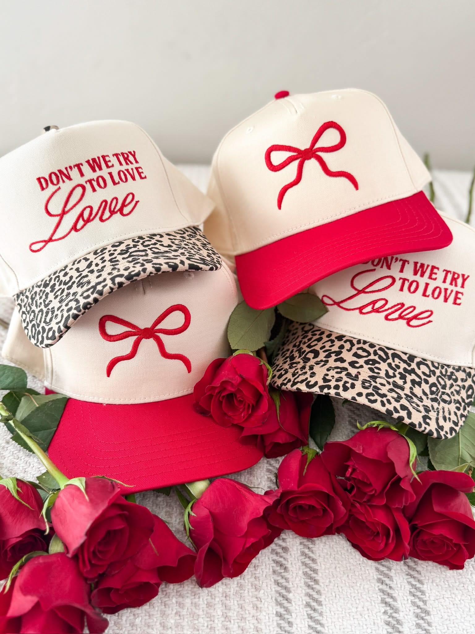 Adult cream and leopard hat with "Don't We Try To Love Love" design embroidered on front, shown on flat lay – Little Mama Shirt Shop