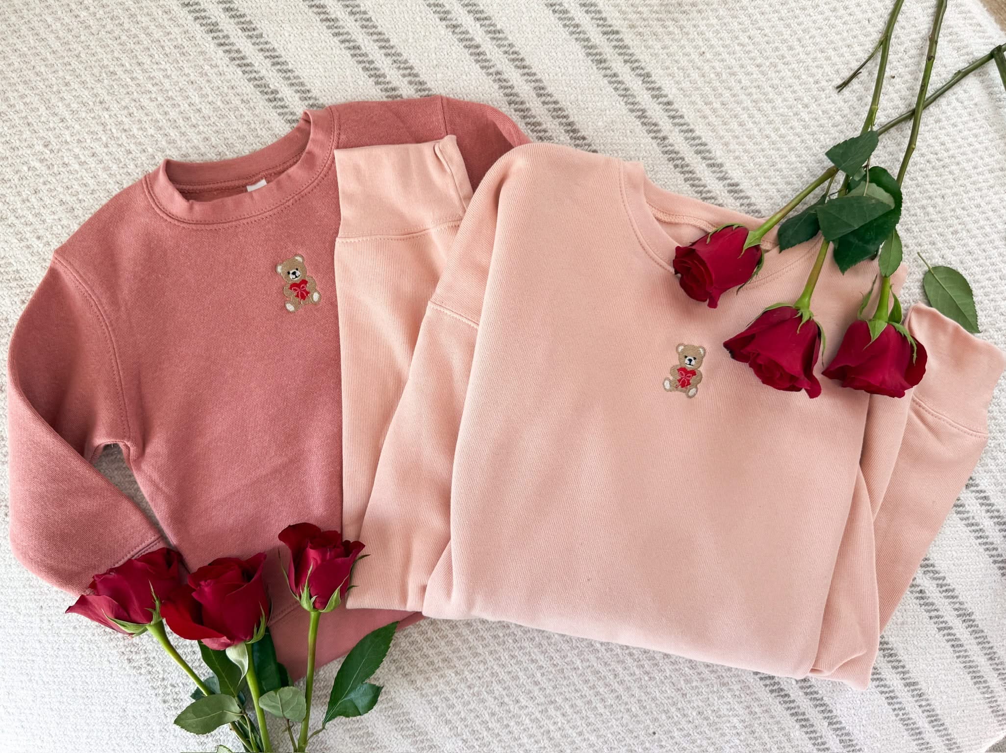 Child mauvelous and Adult pink sweaters with valentine's teddy Embroidery on front, shown on flat lay  – Little Mama Shirt Shop
