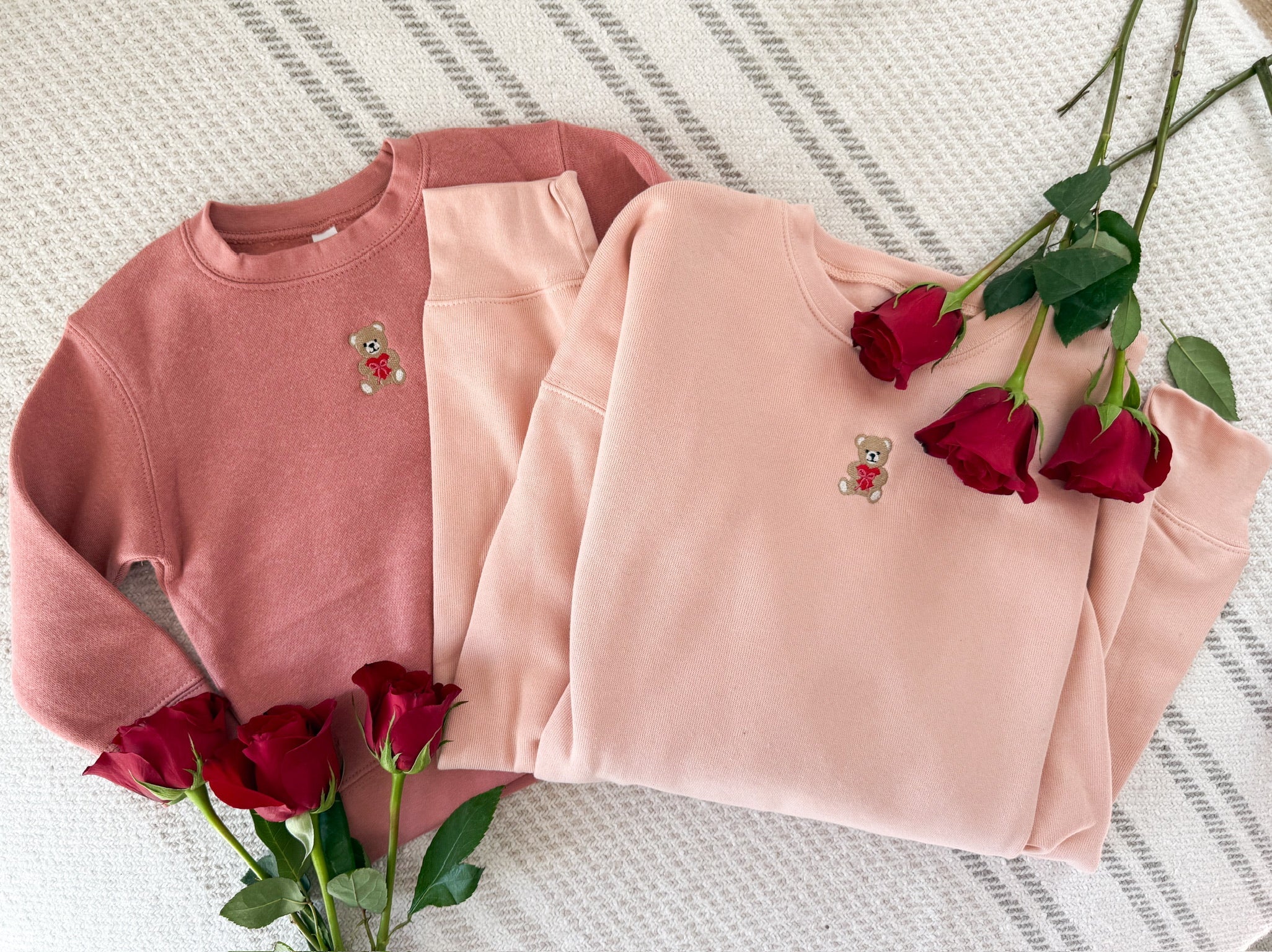 Child mauvelous and adult pink sweater with valentine's teddy Embroidery on front, shown on flat lay  – Little Mama Shirt Shop