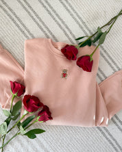 Adult pink sweater with valentine's teddy Embroidery on front, shown on flat lay  – Little Mama Shirt Shop