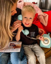Child tee in black with "Little Love Club" bubble letter text design on front left chest, shown on model – Little Mama Shirt Shop