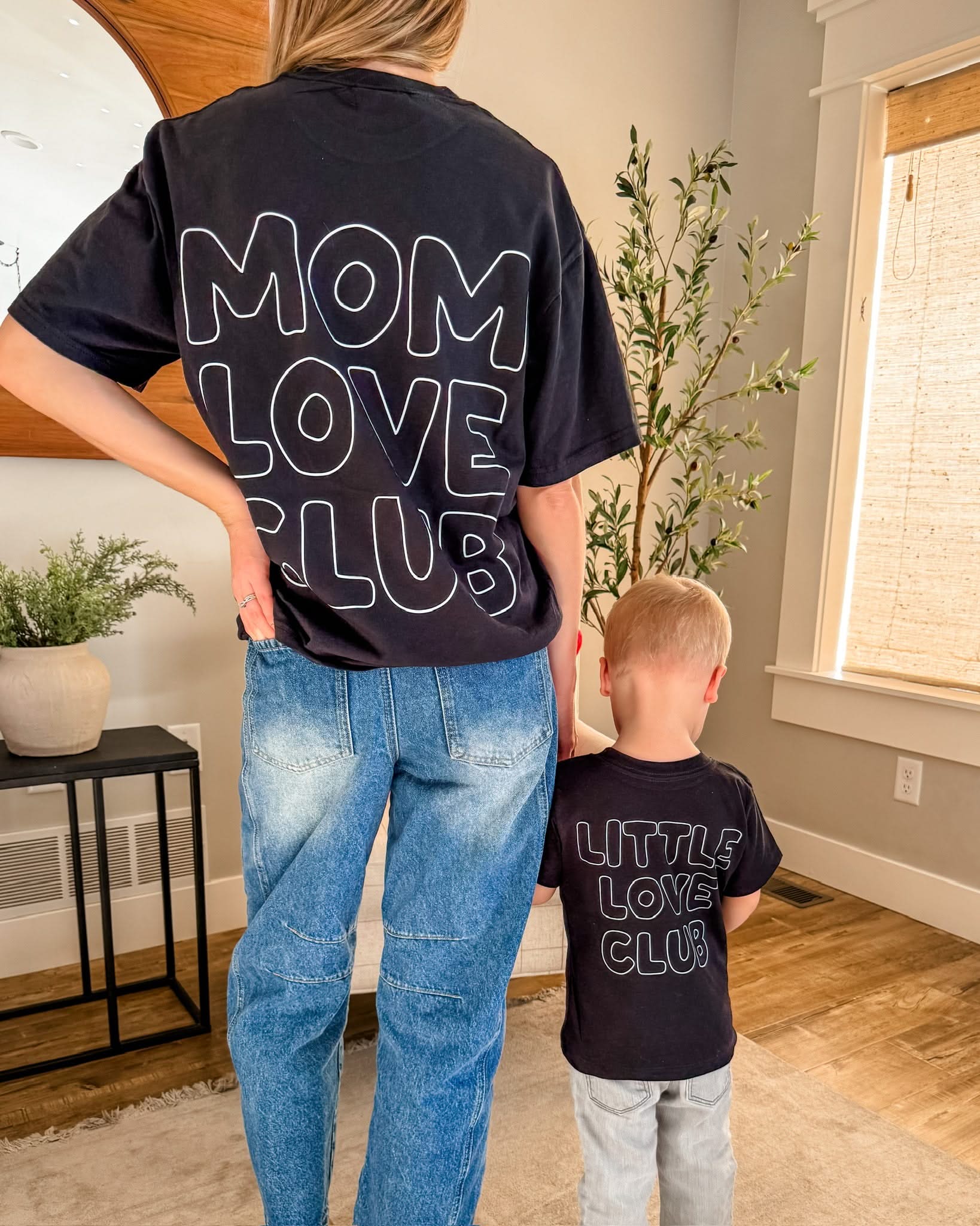 Adult and Child tee in black with "Little Love Club" and "Mom Love Club" bubble letter text design on back, shown on model – Little Mama Shirt Shop