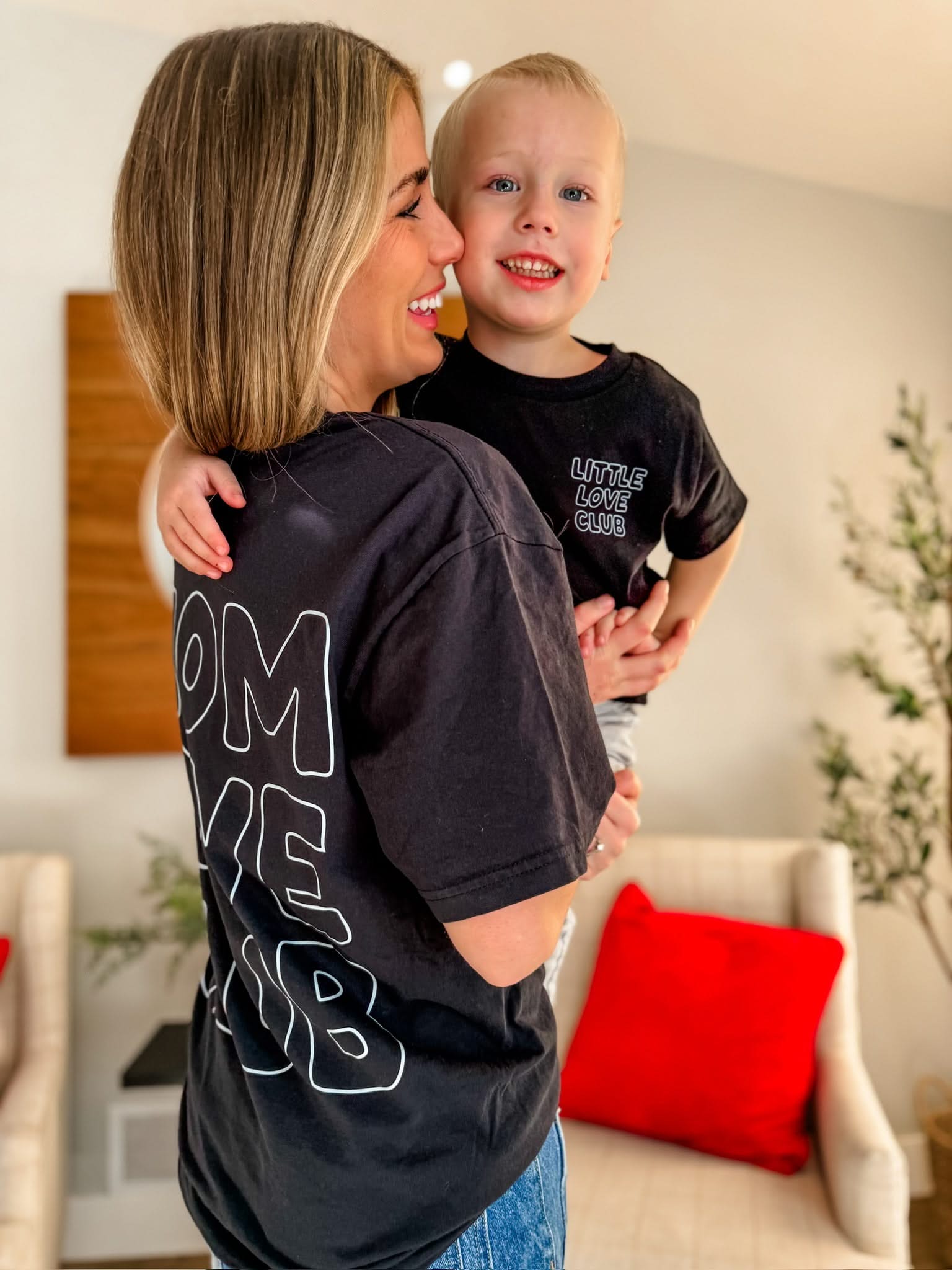 Adult and Child tee in black with "Little Love Club" and "Mom Love Club" bubble letter text design on front left chest and back, shown on model – Little Mama Shirt Shop