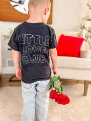 Child tee in black with "Little Love Club" bubble letter text design on back, shown on model – Little Mama Shirt Shop