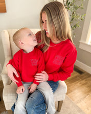 Adult and Child sweater in red with "Little Love Club" and "Mom Love Club" bubble letter text design on front left chest, shown on model – Little Mama Shirt Shop