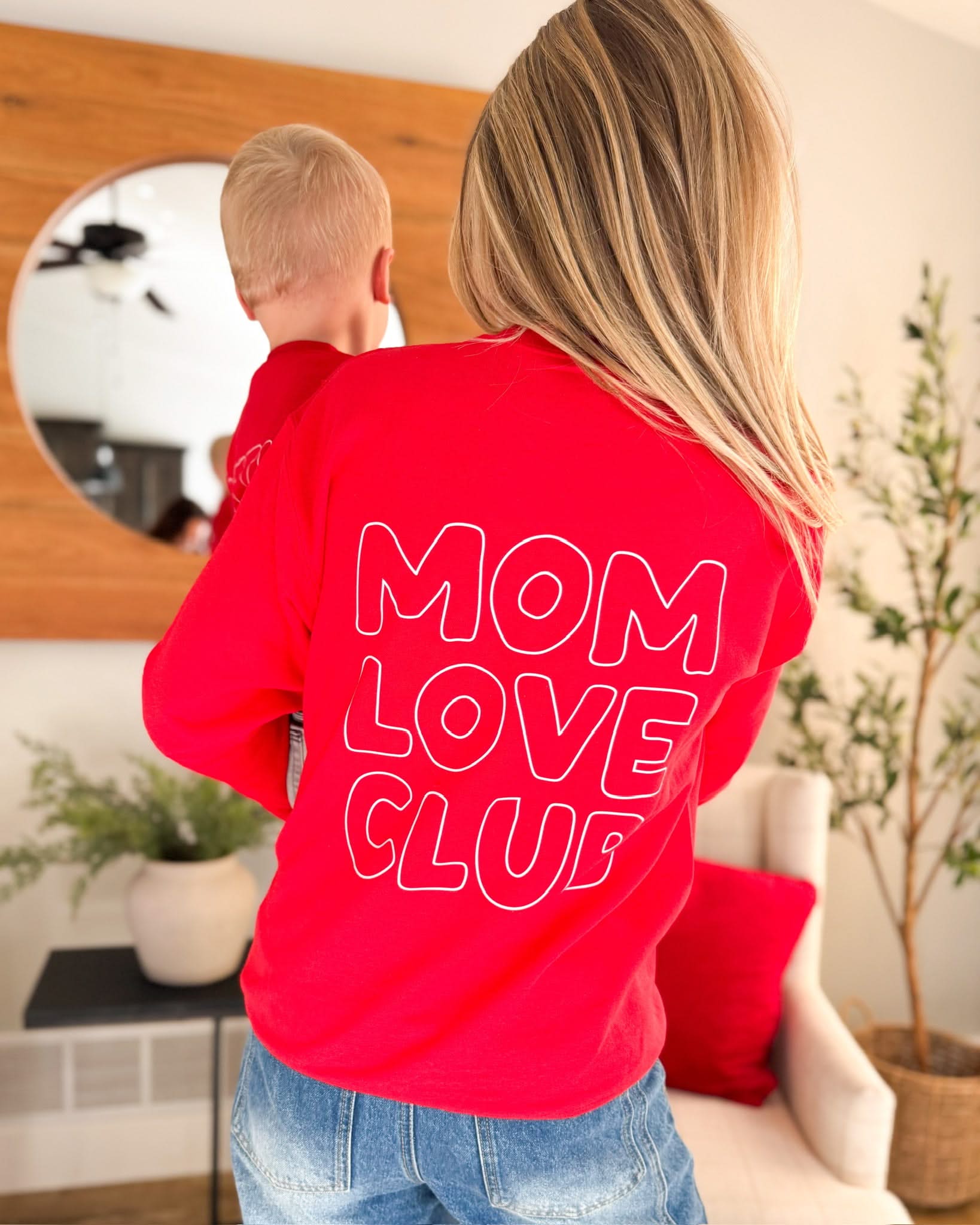 Adult  sweater in red with  "Mom Love Club" bubble letter text design on back, shown on model – Little Mama Shirt Shop