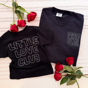 Adult and Child tee in black with "Little Love Club" and "Mom Love Club" bubble letter text design on front left chest and back, shown on flat lay – Little Mama Shirt Shop