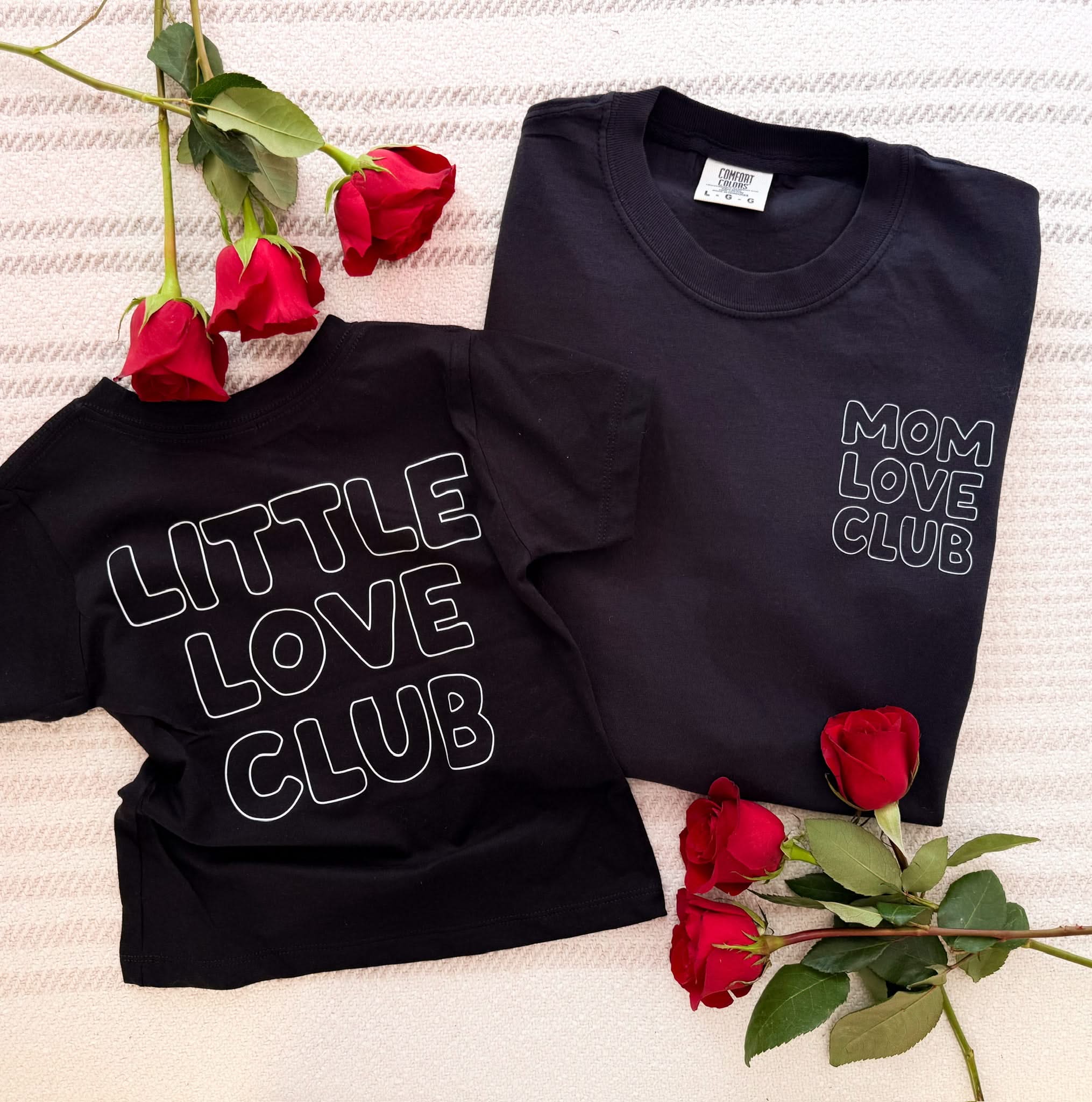 Adult and Child tee in black with "Little Love Club" and "Mom Love Club" bubble letter text design on front left chest and back, shown on flat lay – Little Mama Shirt Shop