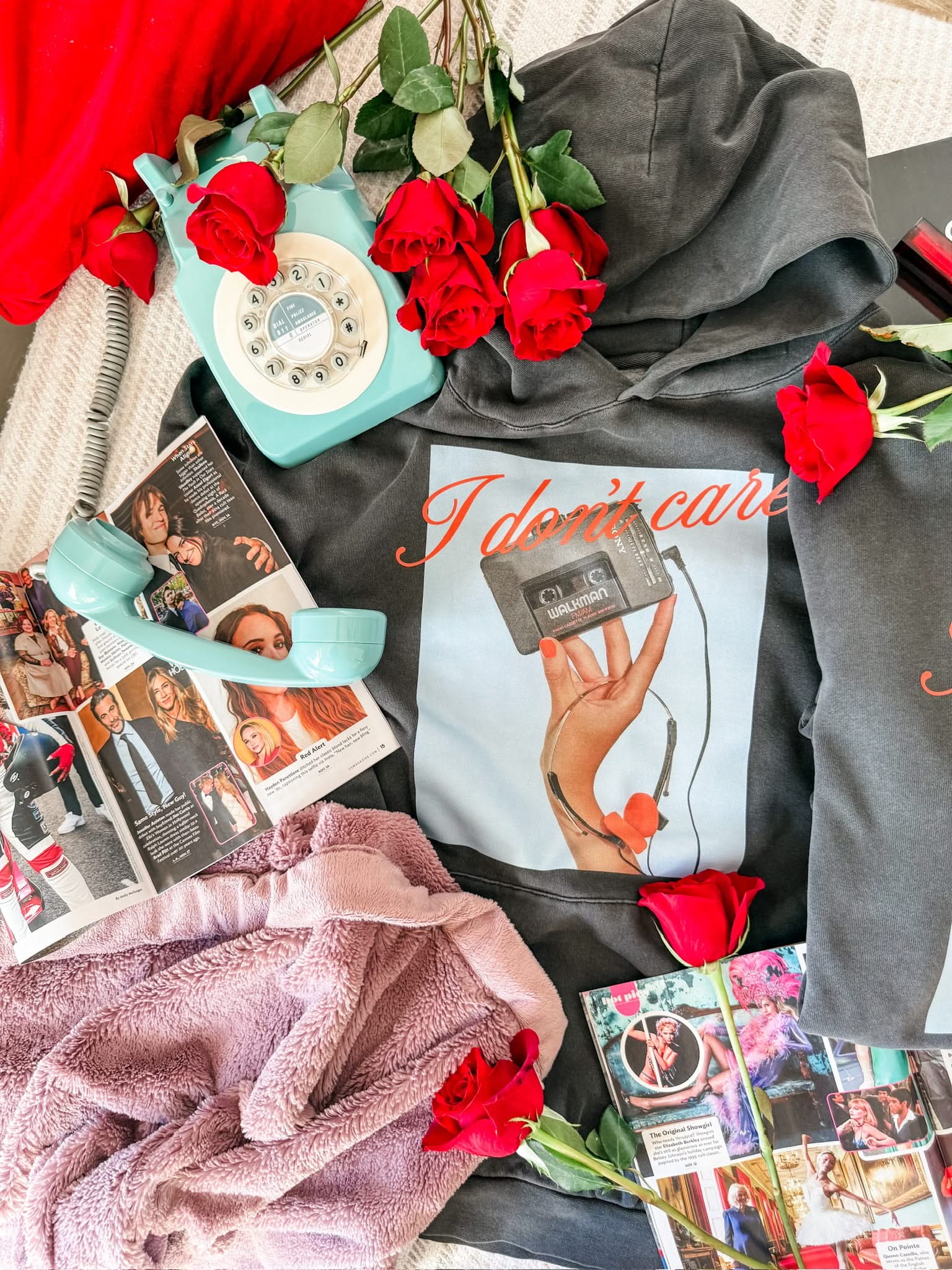 Adult black hoodie with "I Don't Care" retro cassette on front and "JK I Actually Do" text on sleeve, shown on flat lay  – Little Mama Shirt Shop