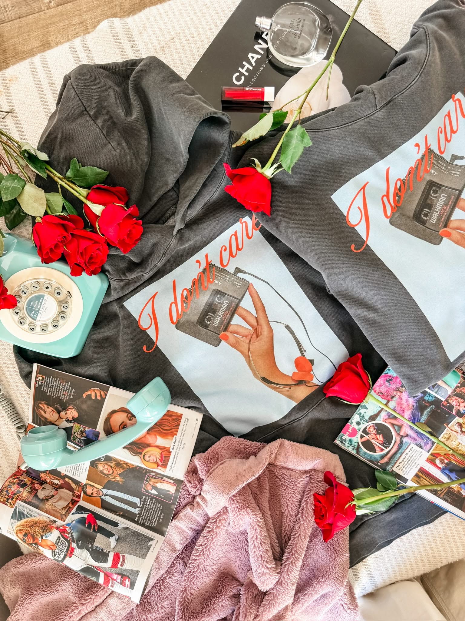 Adult black hoodie with "I Don't Care" retro cassette on front and "JK I Actually Do" text on sleeve, shown on flat lay  – Little Mama Shirt Shop