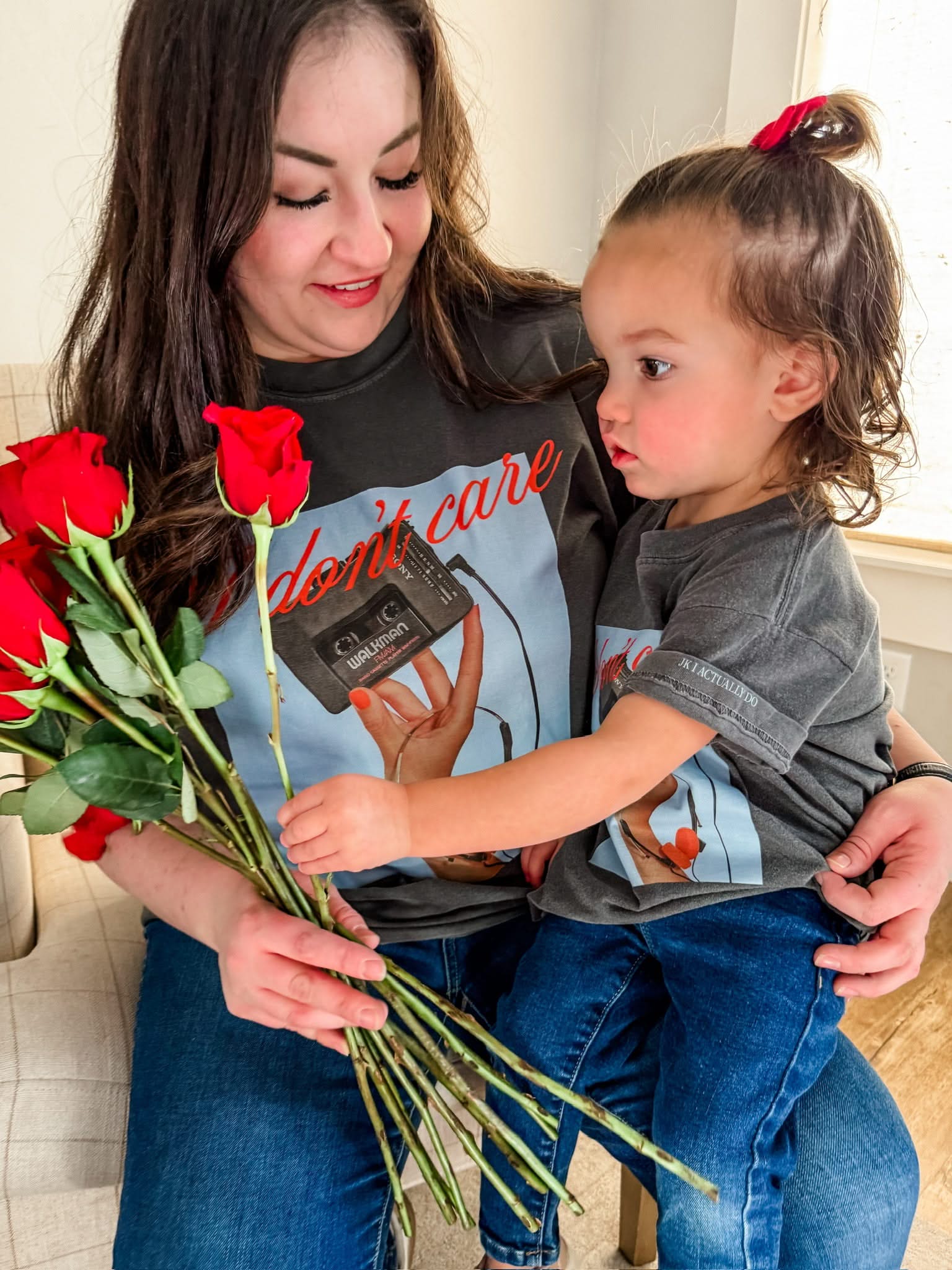Adult and child tee with "I Don't Care" retro cassette on front and "JK I Actually Do" text on sleeve, shown on models  – Little Mama Shirt Shop