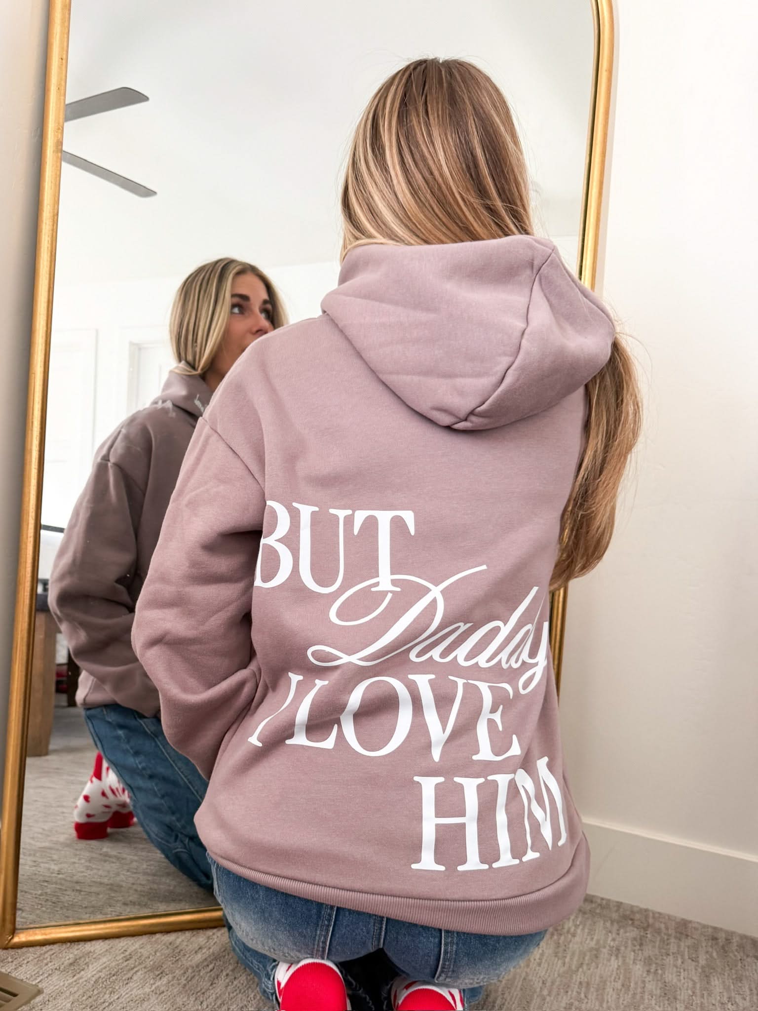 Adult hoodie in brown with "But Daddy I Love Him" design on back and "loml" script on hood, shown on model – Little Mama Shirt Shop
