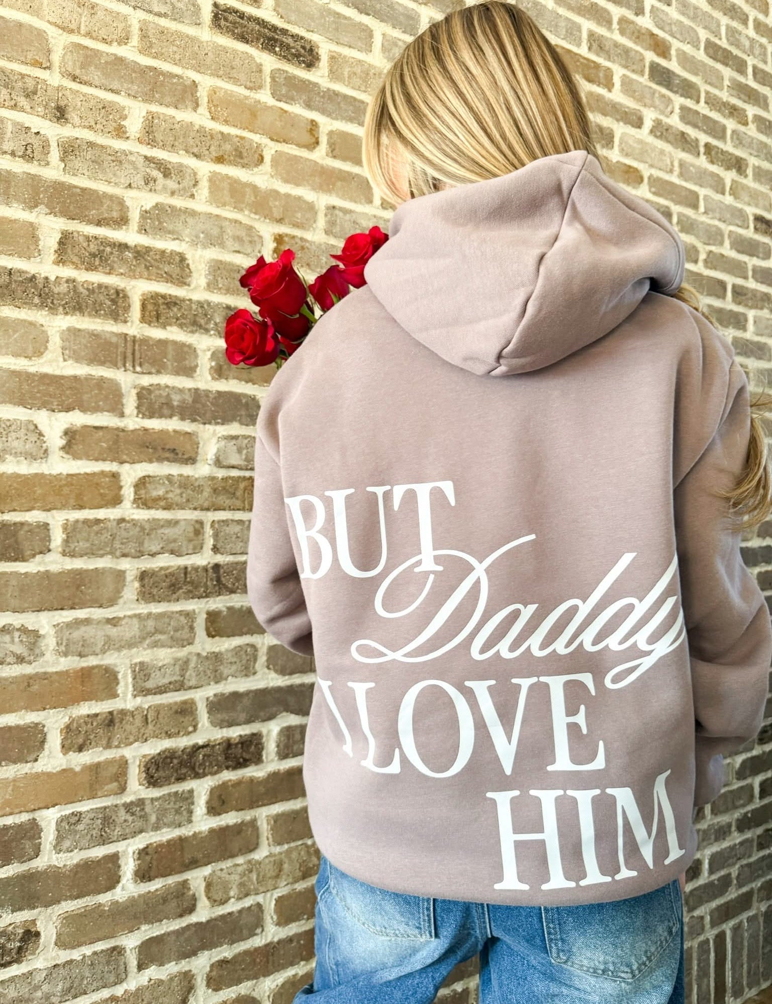 Adult hoodie in brown with "But Daddy I Love Him" design on back, shown on model – Little Mama Shirt Shop