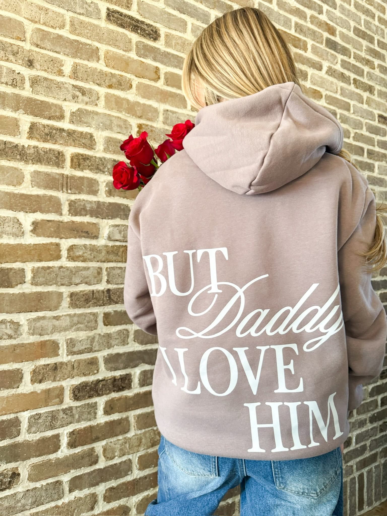Adult hoodie in brown with "But Daddy I Love Him" design on back, shown on model – Little Mama Shirt Shop