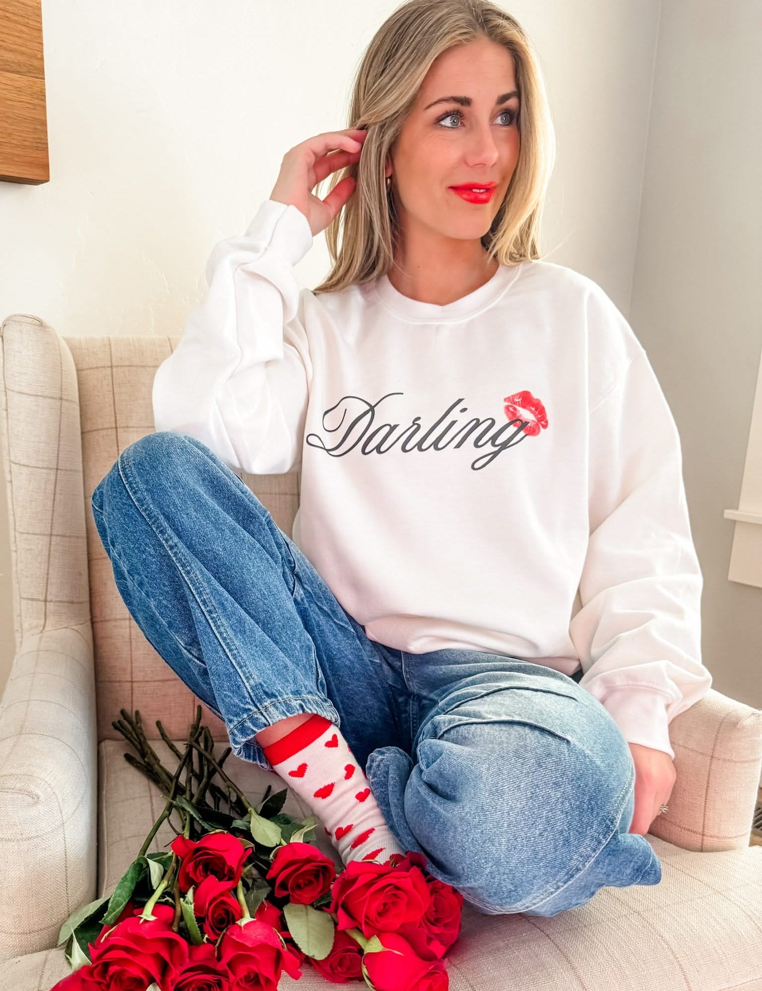 Adult white sweater with "Darling" script and lipstick kiss design, shown on model  – Little Mama Shirt Shop