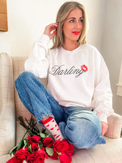 Adult white sweater with "Darling" script and lipstick kiss design, shown on model  – Little Mama Shirt Shop