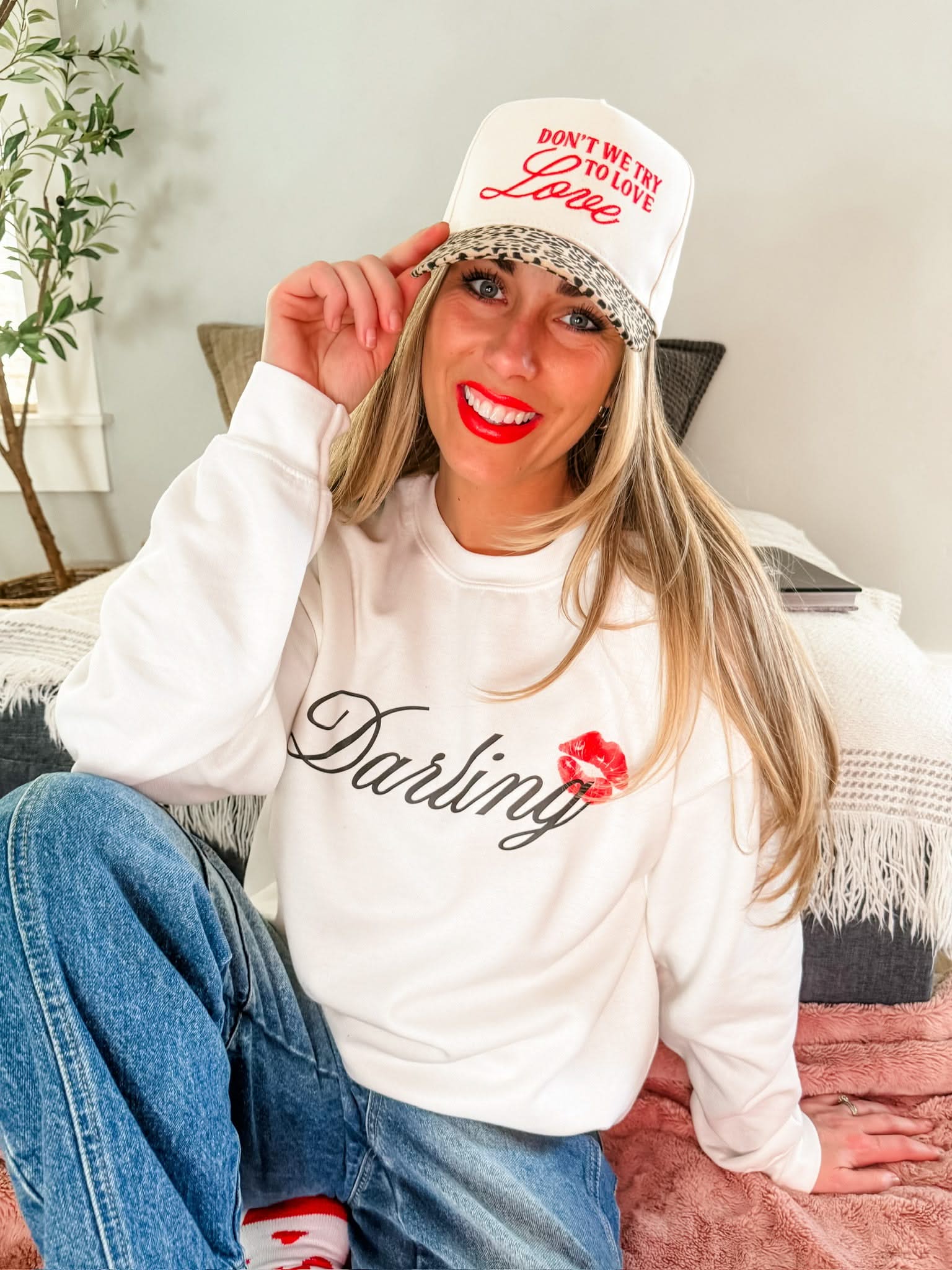 Adult cream and leopard hat with "Don't We Try To Love Love" design embroidered on front, shown on model – Little Mama Shirt Shop