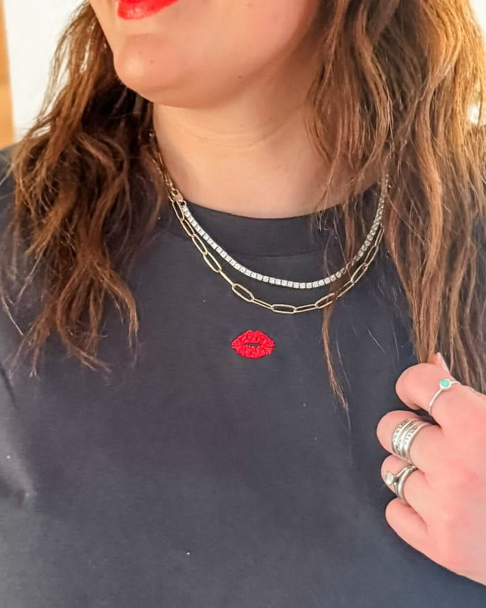 Adult tee in dark gray with mini symbol lips design on front, shown on model – Little Mama Shirt Shop