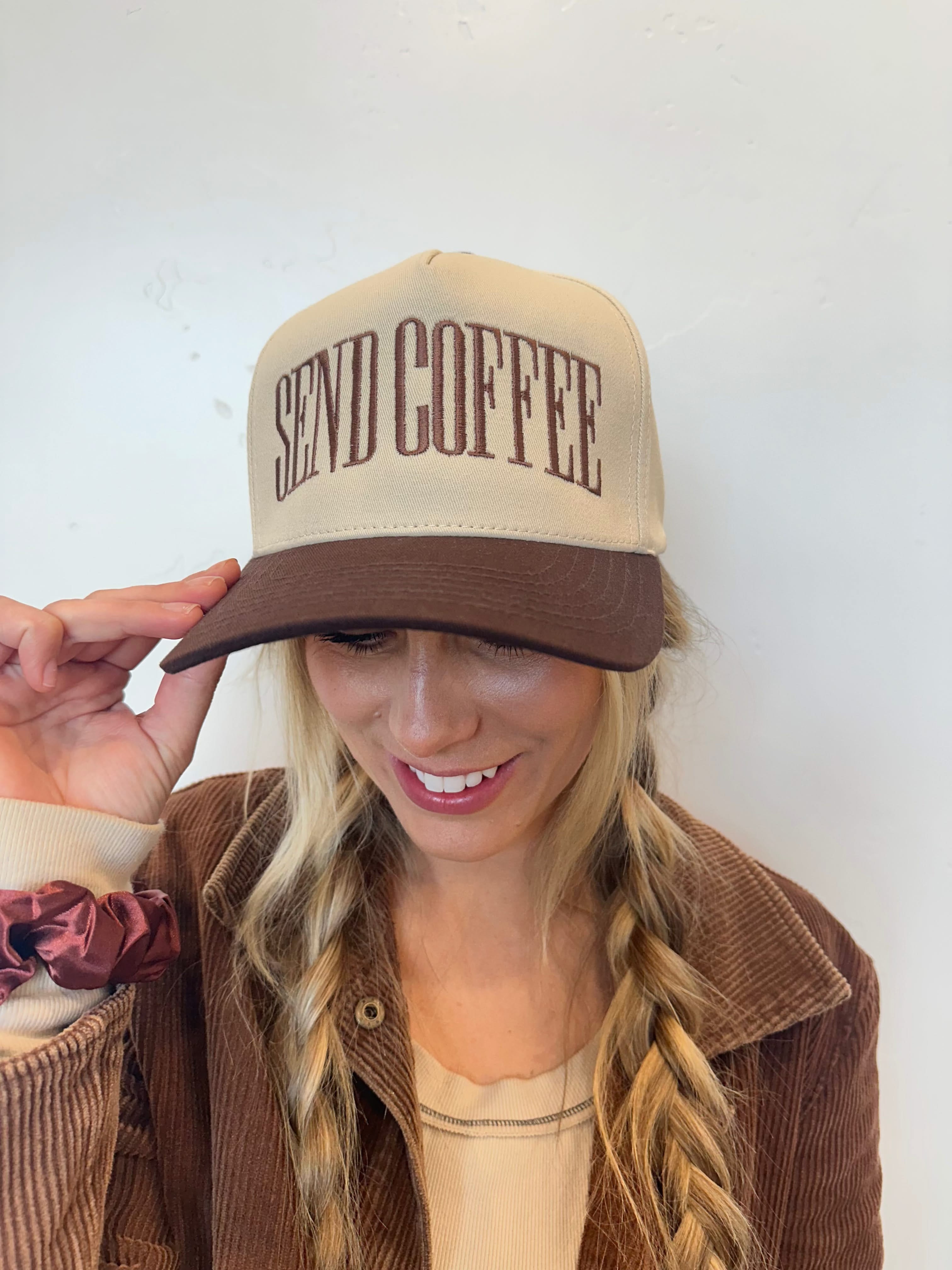 Brown and cream trucker hat with bold brown 'SEND COFFEE' text, seen on model - Little Mama Shirt Shop