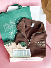 Book lover gift box with green tote, brown folded quarter zip, green 'read more books' socks, and green bookmarks shown in flat lay – Little Mama Shirt Shop