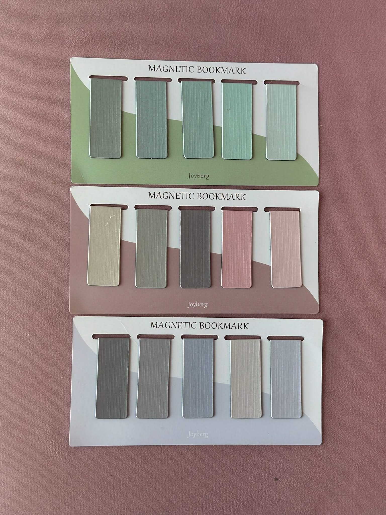 three sets of 5 magnetic bookmarks in green, pink, and purple shown on flat lay – Little Mama Shirt Shop