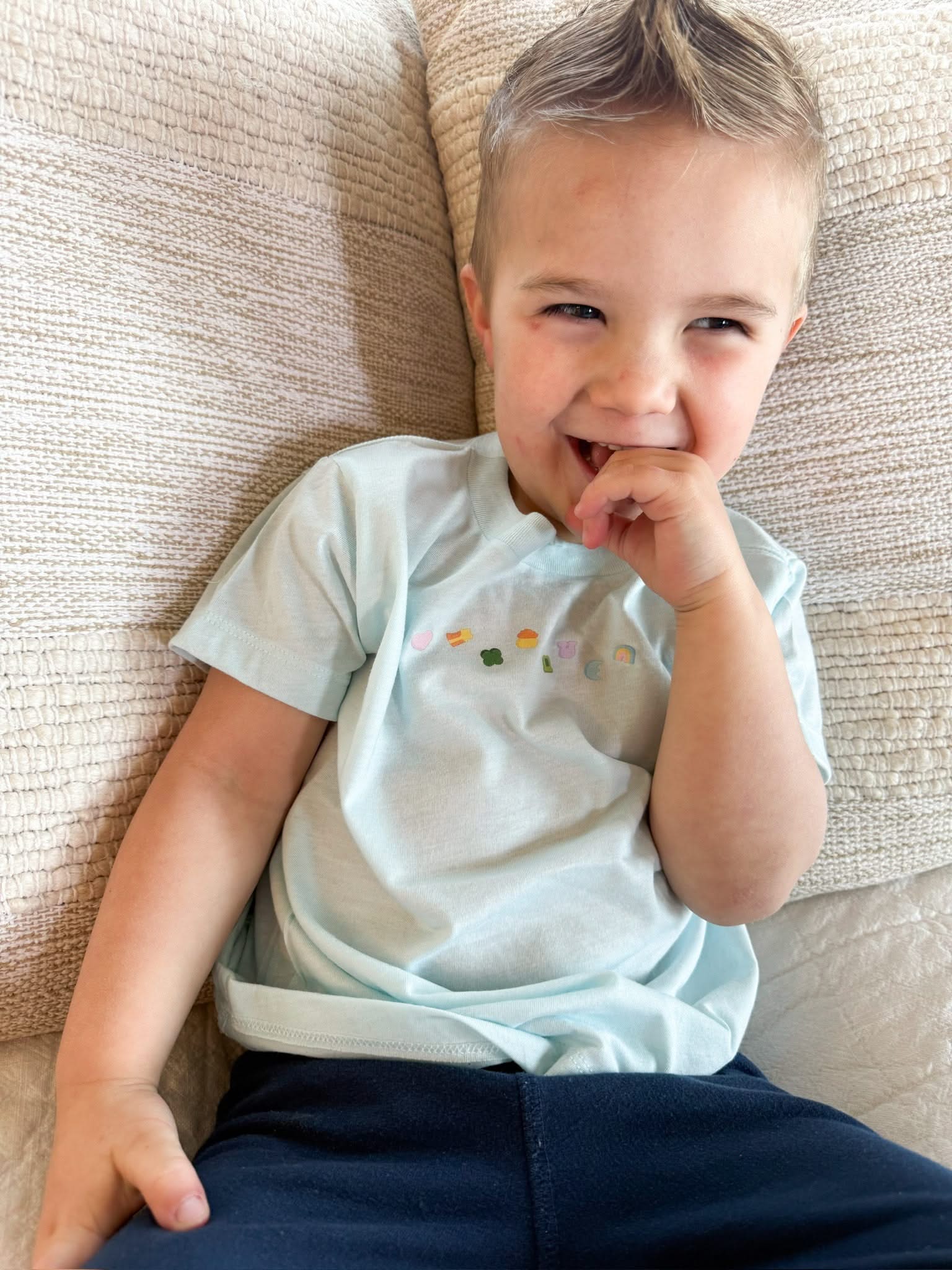 Ice blue child tee with printed lucky charm marshmallows design on chest, seen on model - Little Mama Shirt Shop