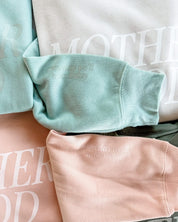 Adult fleece in army green, cream, blush, and mint with 'motherhood' printed on the front in tone on tone and 'someday we'll miss today' printed on sleeve, seen on flat lay - Little Mama Shirt Shop