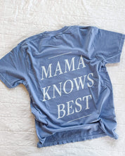 Adult tee in washed denim with 'mama knows best' printed on the back, seen on flat lay - Little Mama Shirt Shop