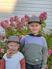 Child hat in brown and checkered with "Bruh" embroidered design, seen on models - Little Mama Shirt Shop