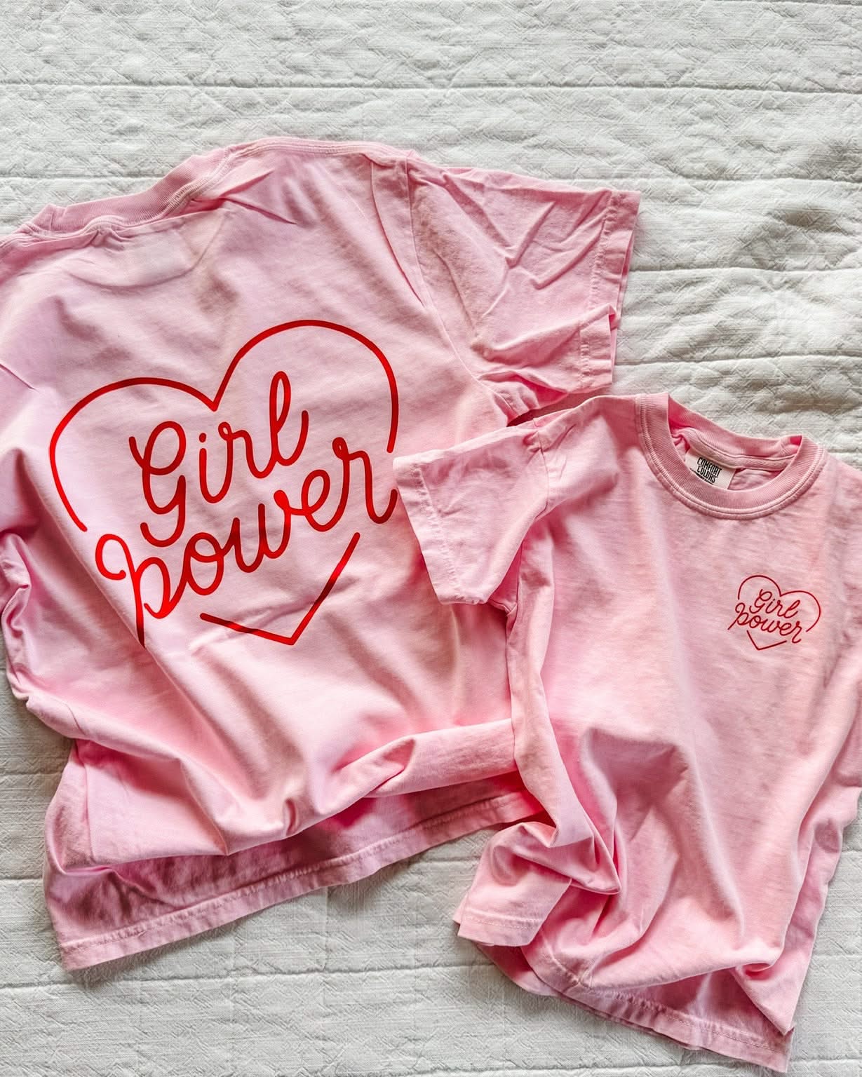 Adult and youth blossom comfort colors tee with girl power script in heart design on pocket and back, seen on flat lay - Little Mama Shirt Shop