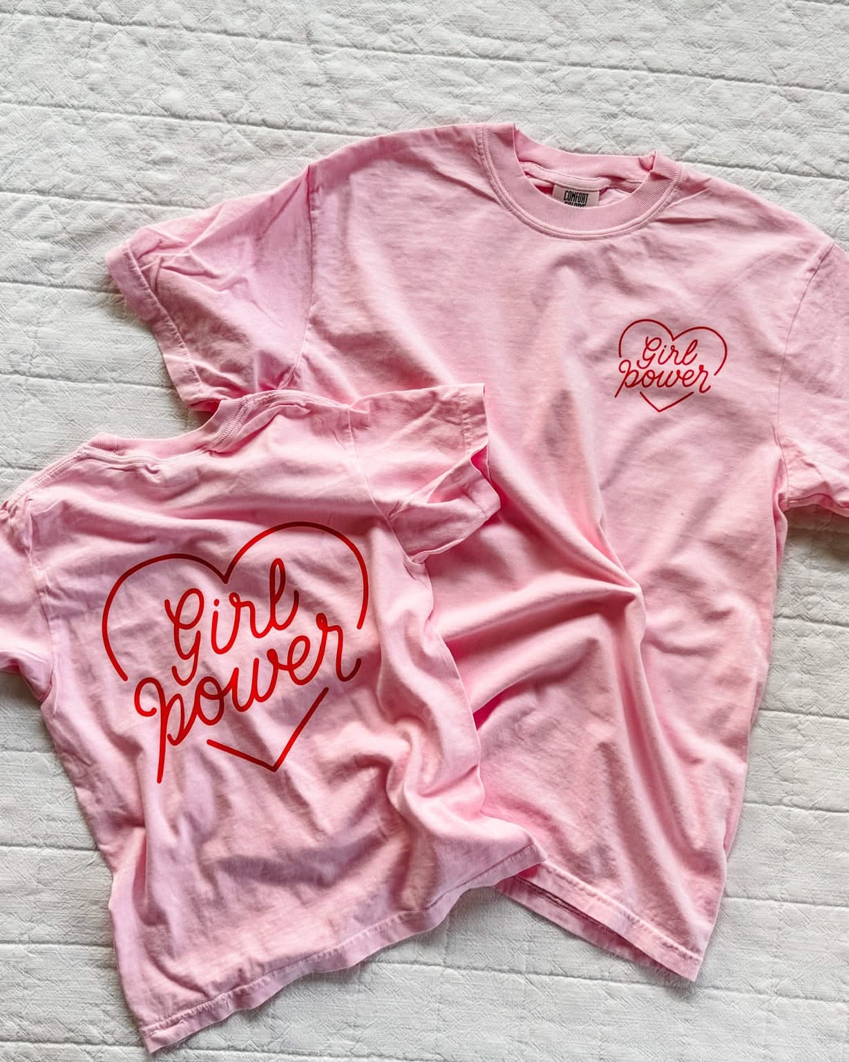Adult and youth blossom comfort colors tee with girl power script in heart design on pocket and back, seen on flat lay - Little Mama Shirt Shop