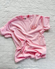 Youth blossom comfort colors tee with girl power script in heart design on pocket, seen on flat lay - Little Mama Shirt Shop