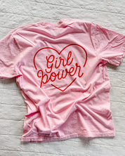 Youth blossom comfort colors tee with girl power script in heart design on back, seen on flat lay - Little Mama Shirt Shop