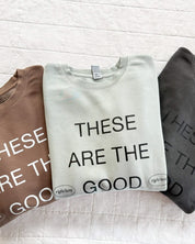 Adult pigment crewneck in brown, sage, and black with 'these are the good old days'  printed on the front, seen on flat lay - Little Mama Shirt Shop