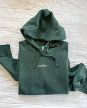 Adult alpine hoodie with mother embroidered on the chest, seen on flat lay - Little Mama Shirt Shop